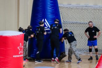 Бойцы LASERWAR в черной форме у синего укрытия.